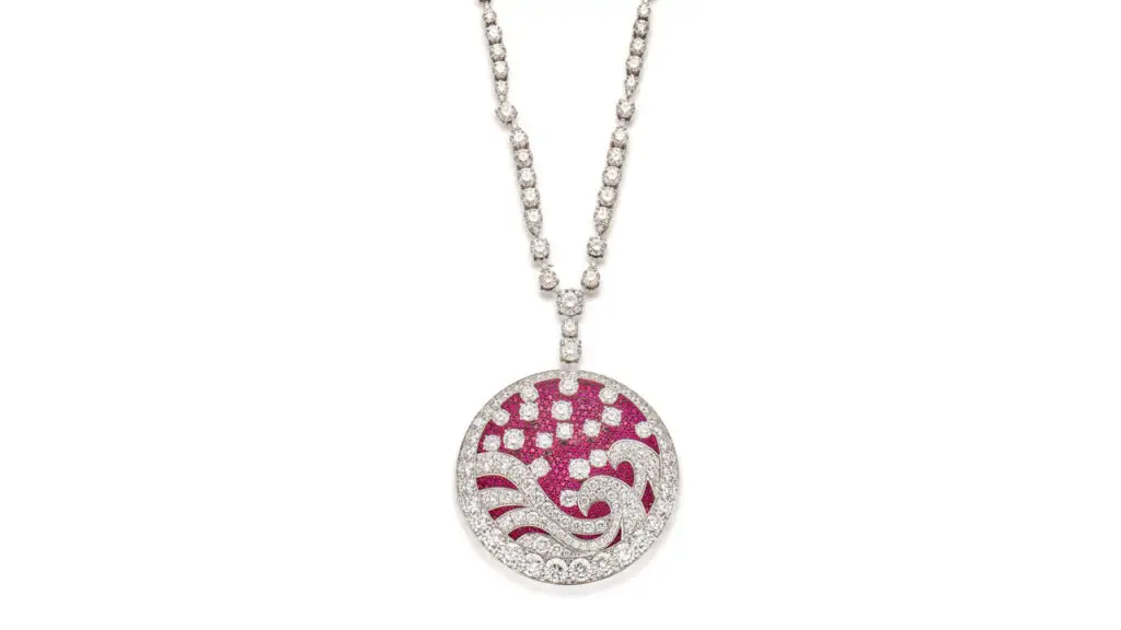 A Graff Wave necklace with a round pendant features a wave motif containing circular-cut rubies and brilliant-cut diamonds attached to a necklace with brilliant-cut diamonds set at intervals image