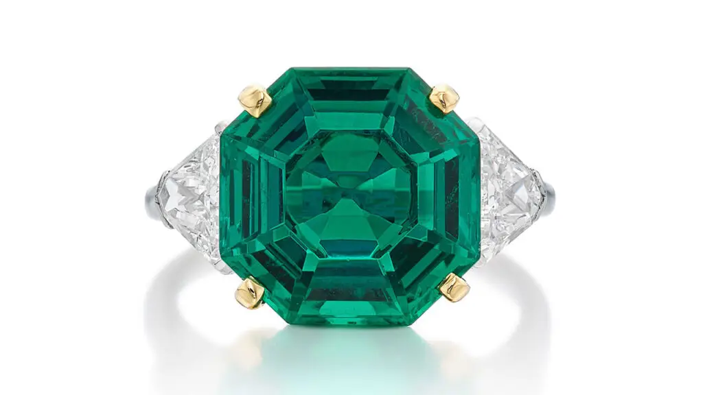 Raymond Yard is the maker of this ring, it bears an octagonal step-cut, 5.43-carat, Colombian emerald as the center stone, with triangle diamond side stones at Sotheby's image