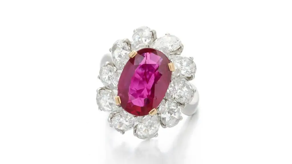 A Bulgari ring bears an oval-shaped Burmese ruby weighing 3.59 carats, in a pear-shaped diamond double frame at Sotheby's image