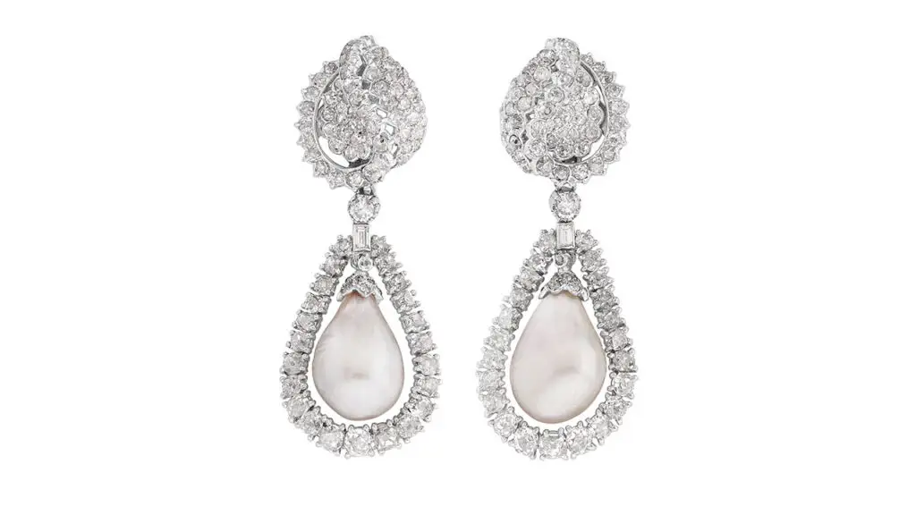 A pair of Monture Cartier earrings, each centering a natural pearl in a diamond surround at Phillips image