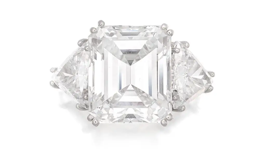 A ring centering a step-cut, 8.54-carat, VS1-clarity diamond with trilliant-cut diamond shoulders at Bonhams image