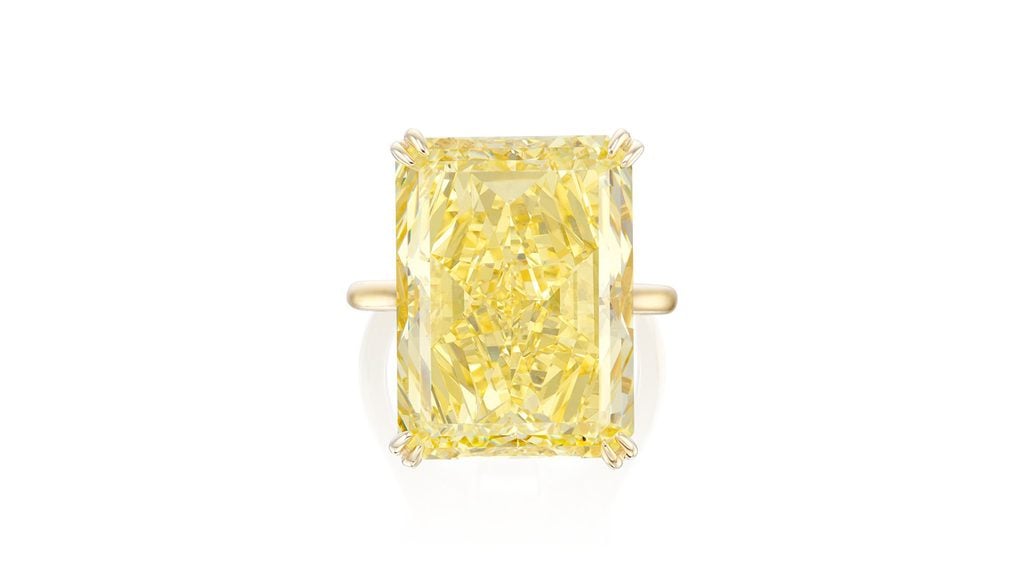 A ring bearing a cut-cornered rectangular mixed-cut, 23.34-carat, fancy-intense-yellow, VVS1-clarity diamond at Phillips image