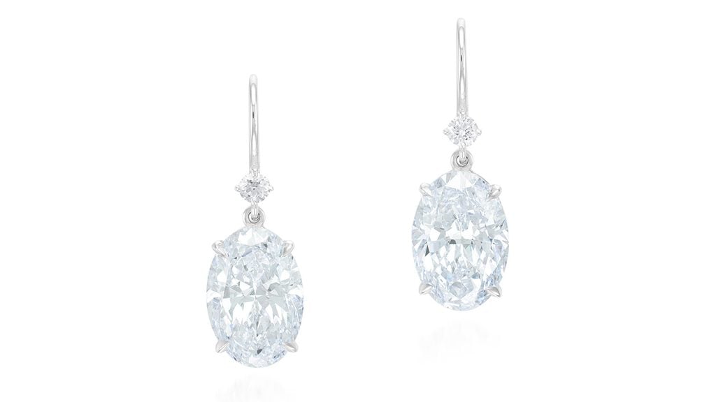 A pair of earrings sporting oval diamonds, one a 7.02-carat, E-color, VVS2 and the other a 7.04-carat, F, VVS2, each suspended from a brilliant-cut diamond at Phillips image