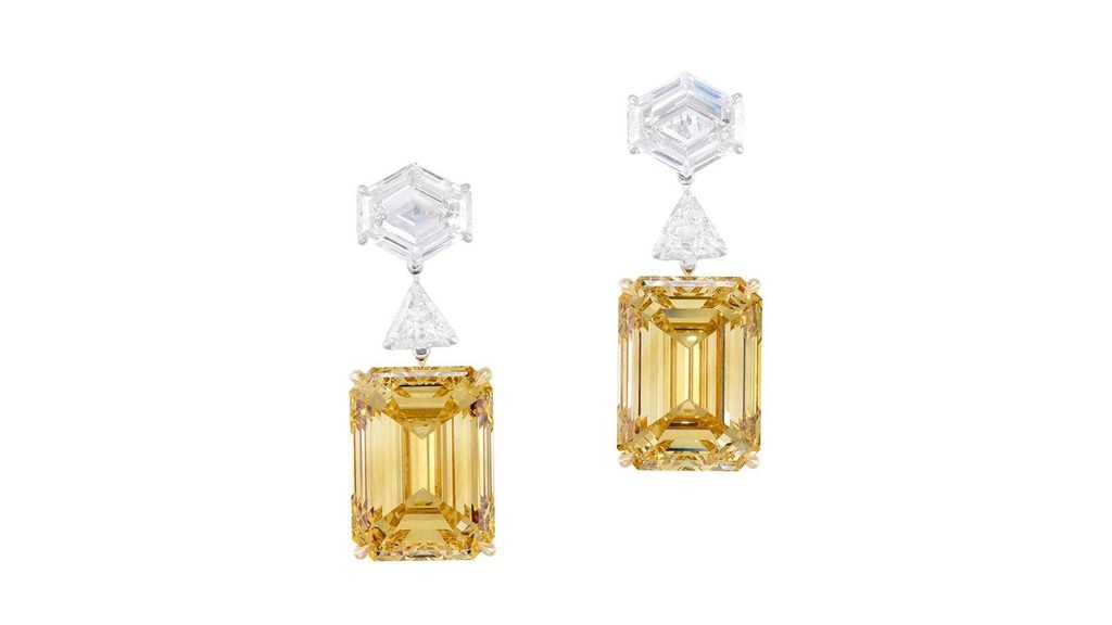 A pair of earrings sporting step-cut, fancy-brown-yellow diamonds, one a 12.55-carat, VS2 and the other 12.56-carat, VS1 stone, each suspended from a modified hexagonal step-cut diamond and spaced by a triangular-shaped diamond at Phillips image