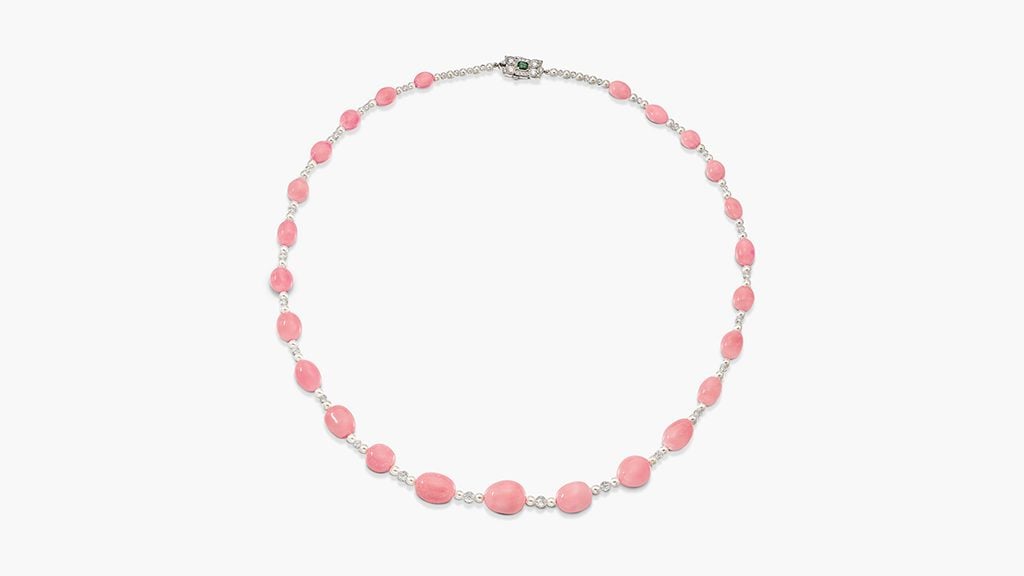 This necklace comprises a graduated row of drop-shaped conch pearls measuring between 6.4 and 12.45 millimeters, alternating with cultured pearls and diamond briolette beads. The clasp contains a step-cut 0.30-carat emerald in a brilliant-cut diamond surround, with six additional conch pearls at Sotheby's image