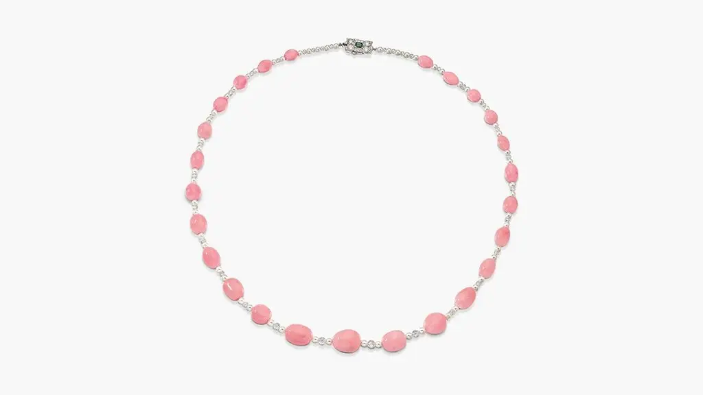 This necklace comprises a graduated row of drop-shaped conch pearls measuring between 6.4 and 12.45 millimeters, alternating with cultured pearls and diamond briolette beads. The clasp contains a step-cut 0.30-carat emerald in a brilliant-cut diamond surround, with six additional conch pearls at Sotheby's image
