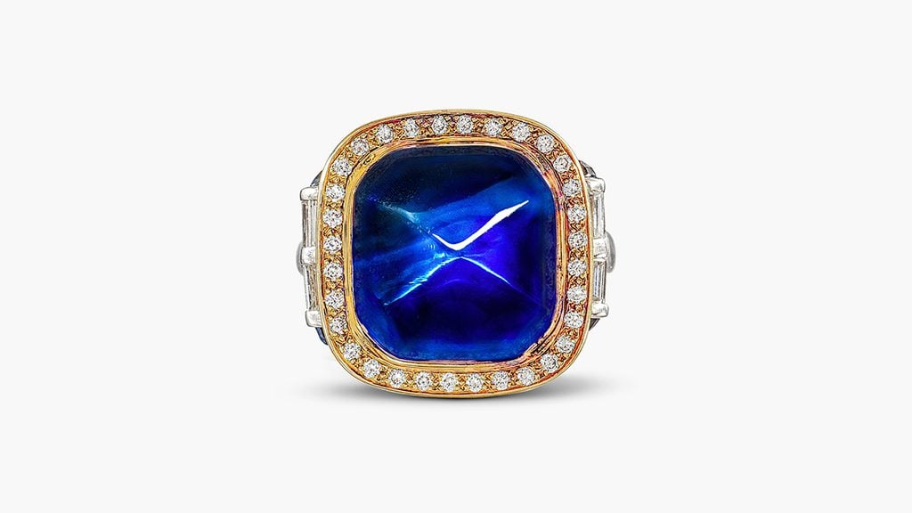 A ring with a sugarloaf, 20.84-carat Kashmir cabochon sapphire in a baguette and brilliant-cut diamond frame at Sotheby's image