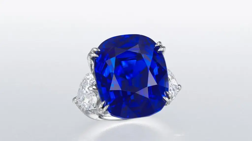Ring featuring an antique cushion brilliant-cut Burmese sapphire center stone bracketed by heart-shaped and round diamonds at Christie's image