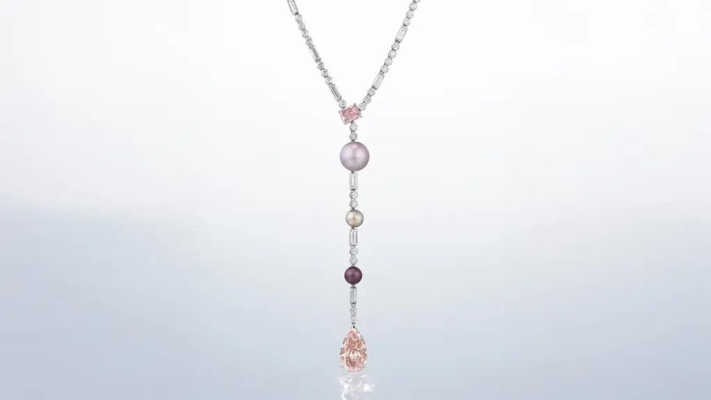 Cartier necklace featuring a pear modified brilliant-cut fancy-intense-orangey-pink diamond, a cut-cornered rectangular modified brilliant-cut fancy-intense-pink diamond and variously colored button-shaped natural pearls at Christie's image