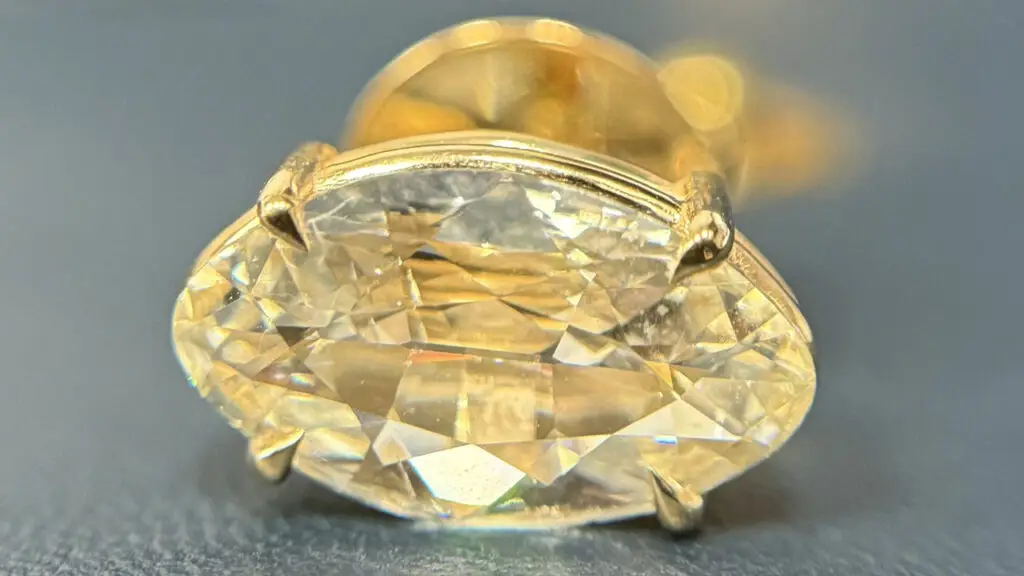 A marquise-cut stud earring featuring a honey-colored natural De Beers Desert Diamond, designed by Marvin Douglas by A Diamond is Forever image
