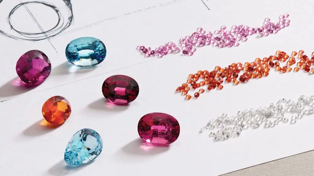 A sketch of a Pomellato ring next to a selection of gemstones image
