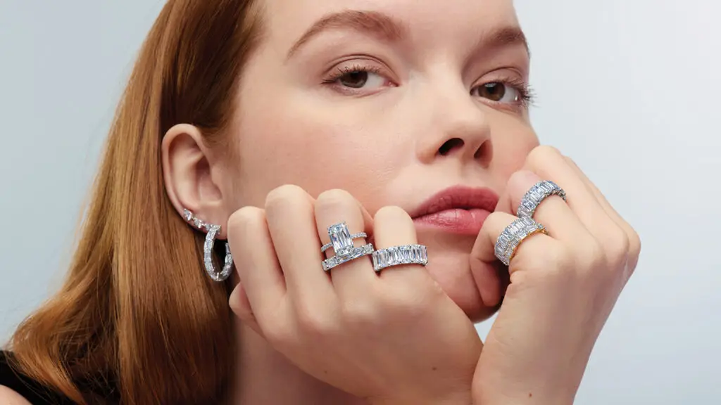 Selection of Ashoka-cut diamond jewelry by Kwiat worn by a model image