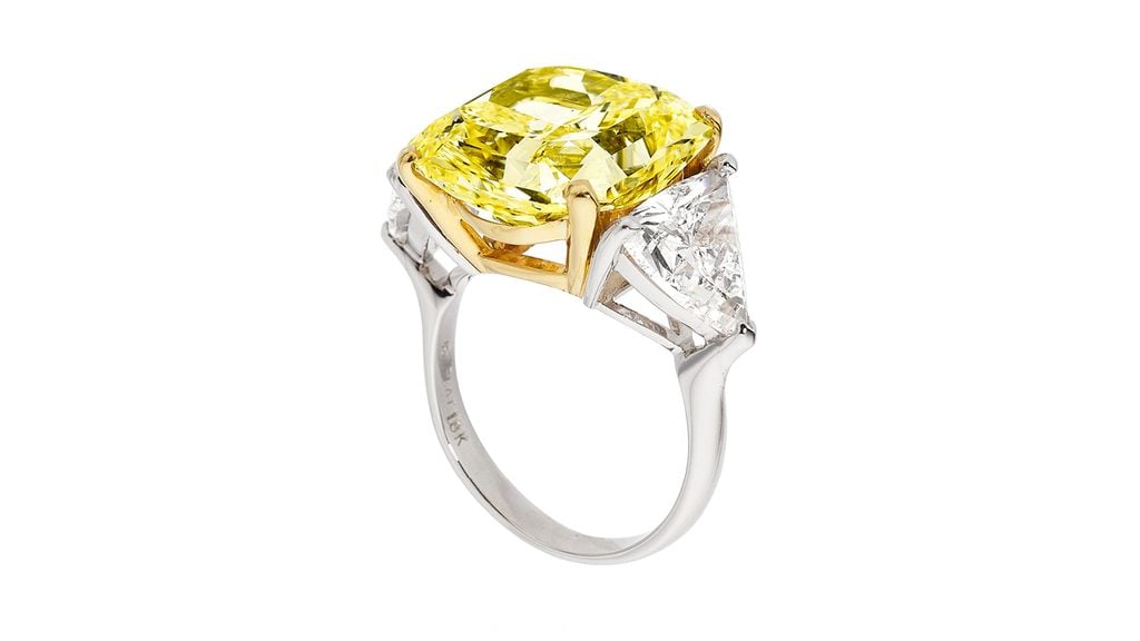 An Oscar Heyman ring starring a rectangular-shaped, 14.11-carat, fancy-yellow, VVS2 diamond, between triangular-shaped diamonds weighing 2.09 and 2.24 carats at Heritage Auction image