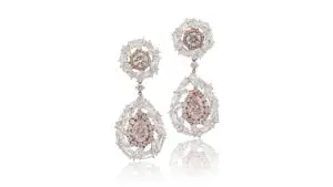The pair of colored-diamond earrings at Sotheby's image