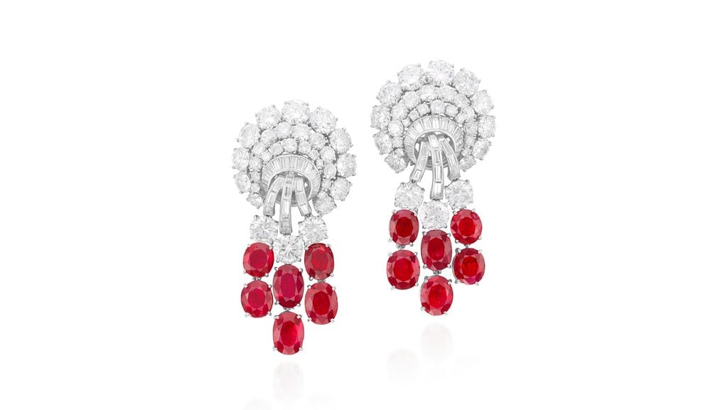 A pair of Harry Winston ruby and diamond ear clips, each featuring six rubies of Burmese and Madagascan origin, suspended from brilliant- and baguette-cut diamonds. The total ruby weight is 18.26 carats at Phillips image