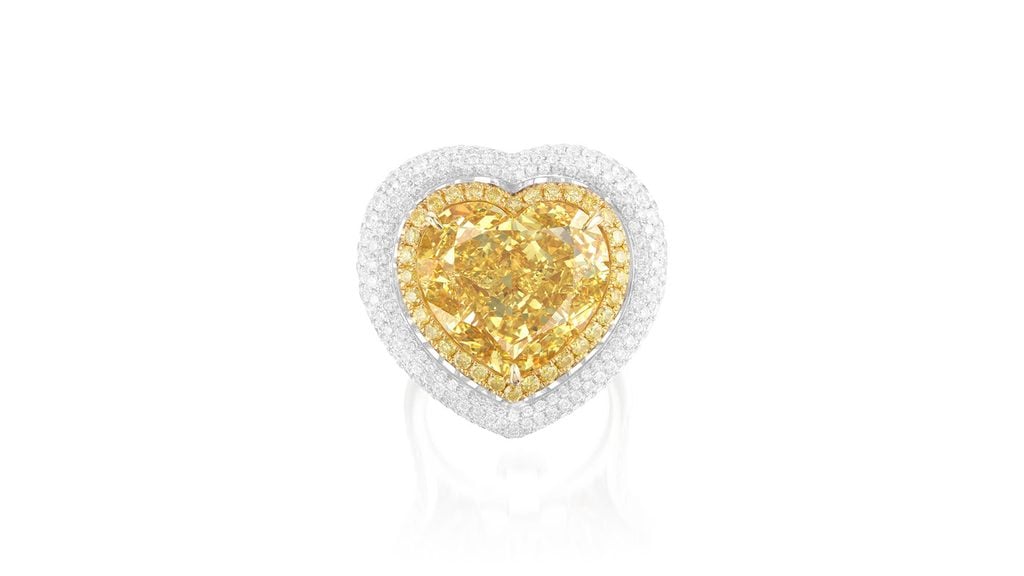 This piece can be worn as a ring or a pendant. It features a heart-shaped, 15.05-carat, fancy-intense-yellow, VVS1 diamond, in a surround of brilliant-cut diamonds of yellow tint, with a pavé-set brilliant-cut diamond frame and shoulders at Phillips image
