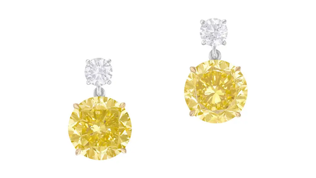 Pair of earrings each featuring a brilliant-cut, fancy-intense-yellow diamond at Phillips image