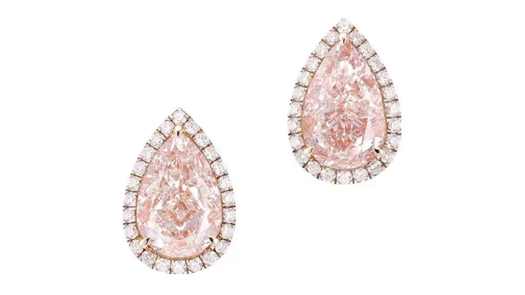 Pair of earrings each containing pear-shaped diamonds with a brilliant-cut diamond surround at Phillips image