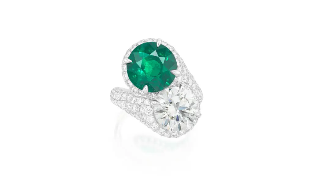 This toi et moi ring features a 5.78-carat Colombian emerald and a brilliant-cut, 4.10-carat diamond accented with a brilliant-cut diamond bombé surround and shoulders at Phillips image