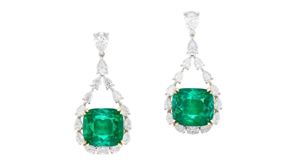 Pair of earrings featuring cushion-shaped Colombian emeralds and pear-shaped and oval diamonds at Phillips image