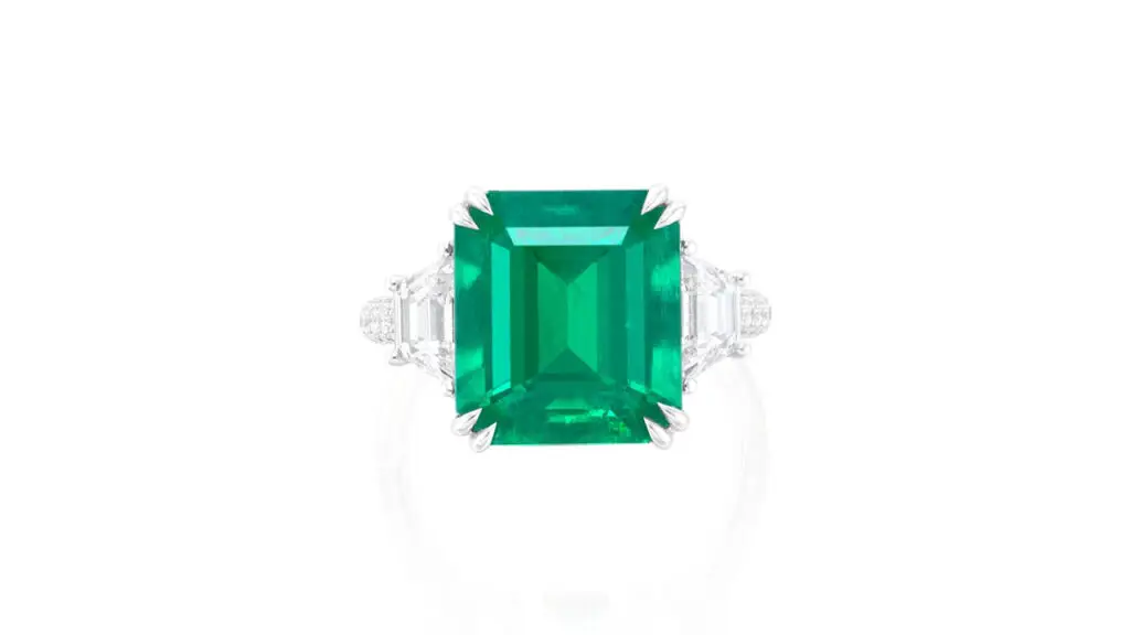 Ring features a step-cut, 7.15-carat Colombian emerald between two trapeze-cut diamonds at Phillips image