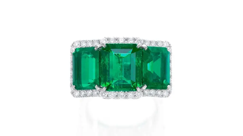 Ring with three step-cut Colombian emeralds surrounded by diamonds at Phillips image