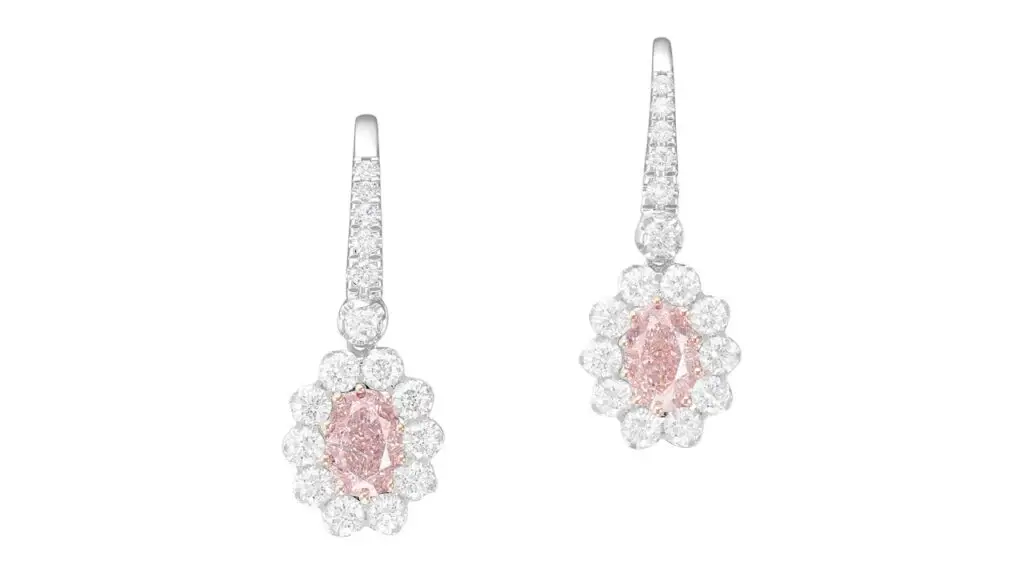 Pair of earrings, each containing an oval-cut, fancy-pink diamond within a diamond surround at Phillips image