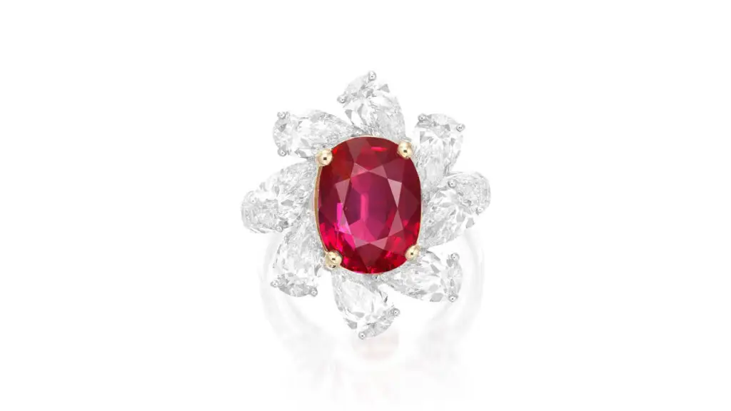 Ring bears an oval, 5.71-carat Burmese ruby in a frame of pear-shaped diamonds at Phillips image