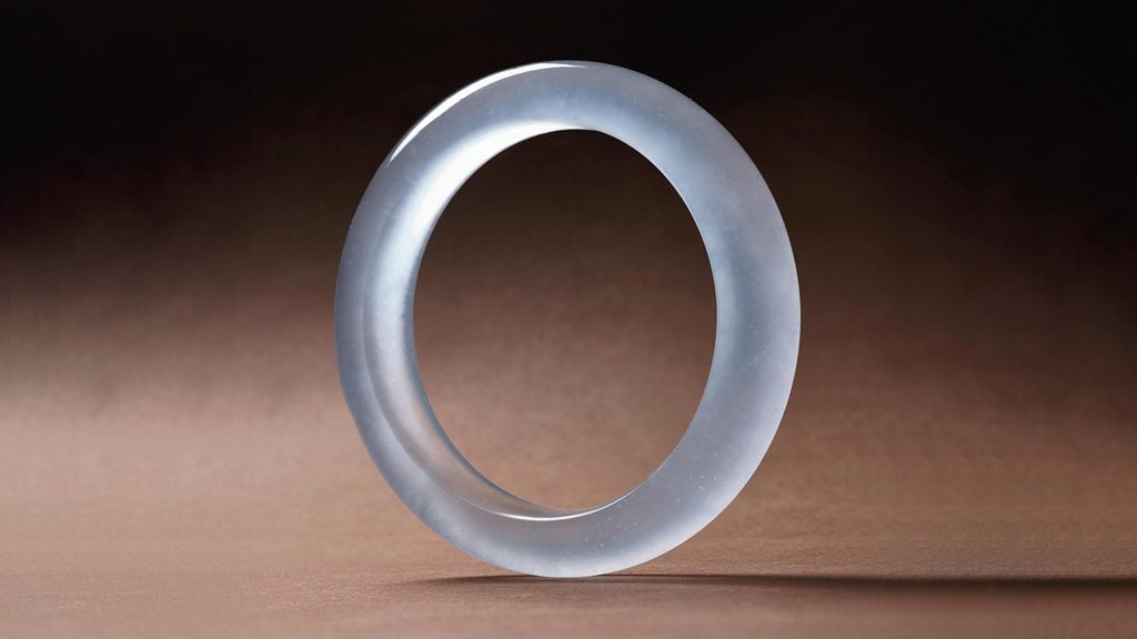 A semi-cylindrical bangle made of icy jadeite at Poly Auction image