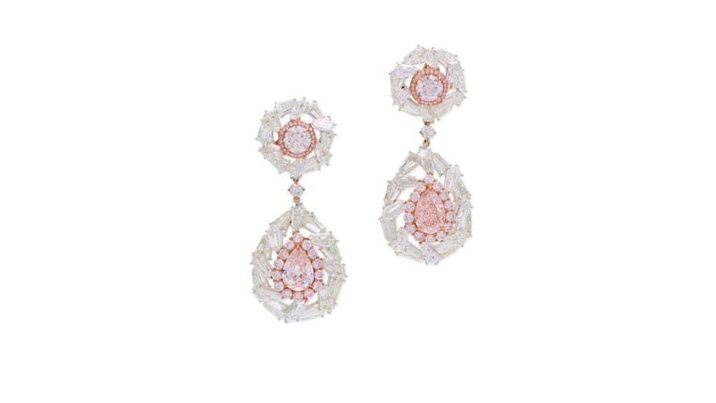 A pair of earrings sold without reserve comprises a pear-shaped, 2.08-carat, light pink diamond and a pear-shaped, 2.21-carat, very-light-pink, VVS1-clarity stone. They are embellished by brilliant-cut diamonds of pink tint as well as kite-shaped ones. The surmounts contain brilliant-cut diamonds in faint and very light pink hues at Sotheby's image