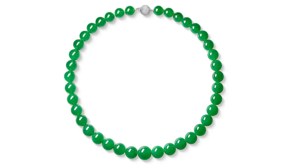 A necklace with 39 graduated intense-green jadeite beads and a brilliant-cut diamond clasp by Sotheby's image