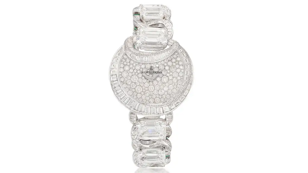 A de Grisogono Luna wristwatch has a half moon-shaped dial and bezel featuring brilliant-cut and baguette diamonds. The diamond-set, circular-link strap contains six principal step-cut diamonds, including a 7.10-carat one, as well as circular- and step-cut emeralds by Sotheby's image