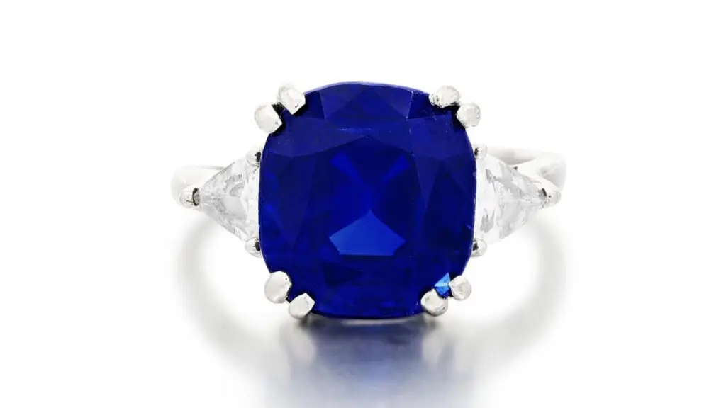 This ring has a cushion-shaped, 10.68-carat Kashmir sapphire between two triangular diamonds by Sotheby's image