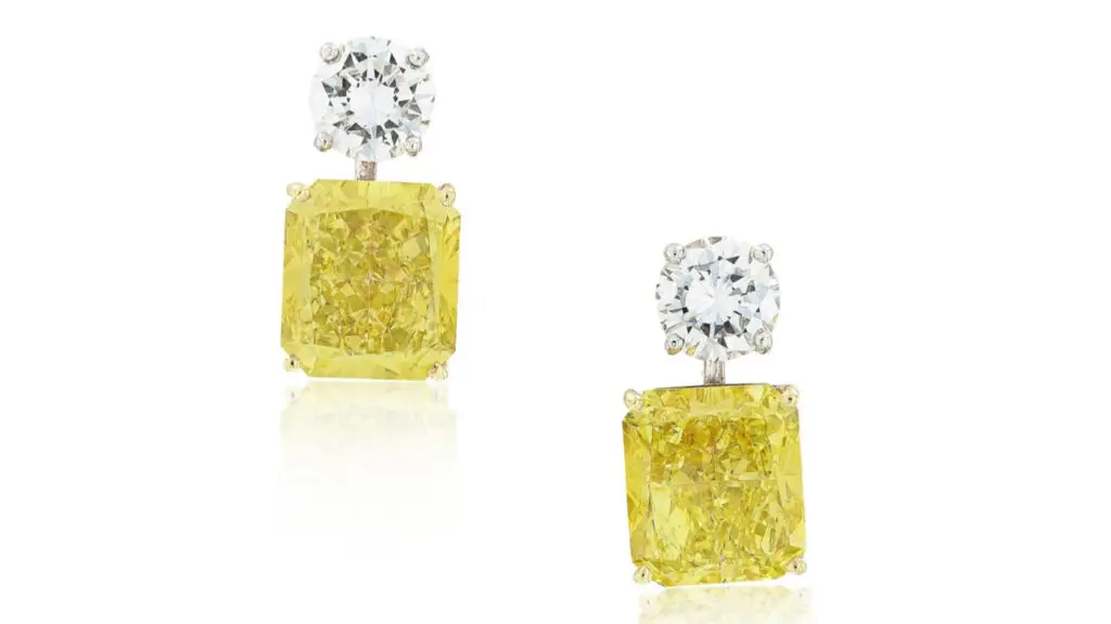 These Graff earrings feature radiant-cut, fancy-intense-yellow diamonds weighing 6.35 and 7.04 carats, suspended from brilliant-cut diamonds by Sotheby's image