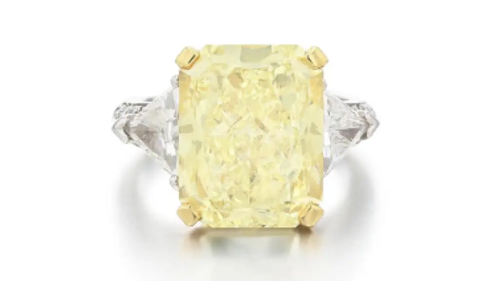 This Graff diamond ring carries a radiant-cut, 10.03-carat, fancy-light-yellow stone between two triangular-cut diamonds by Sotheby's image