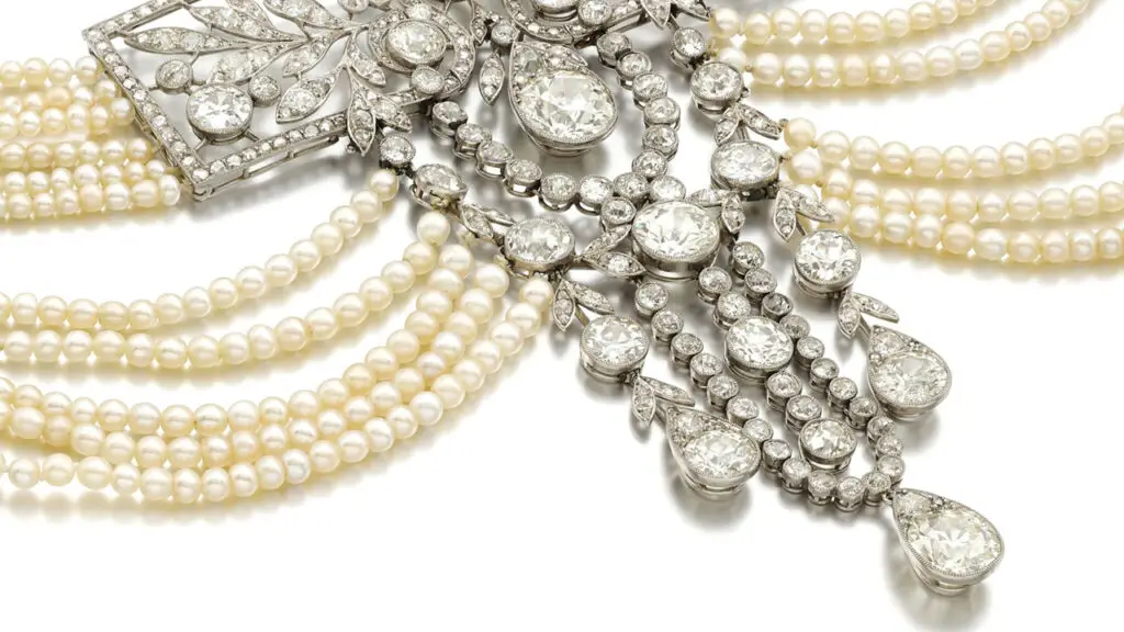 20th-century chocker featuring a rose-cut diamonds, suspending a large pear-shaped diamond in an openwork surround of old brilliant-cut and cushion-shaped diamonds as well as 12 rows of pearls at Sotheby's image