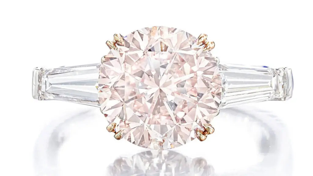Ring set with brilliant-cut internally flawless diamond center stone, flanked by two tapered baguette diamonds at Sotheby’s image
