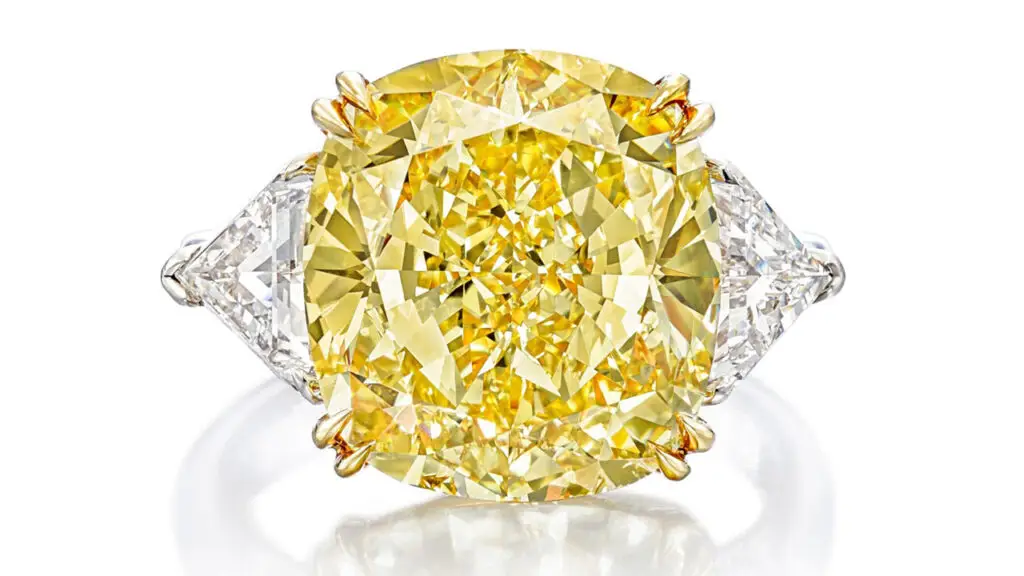 Cushion-shaped fancy-intense-yellow diamond between two triangular diamonds ring at Sotheby's image