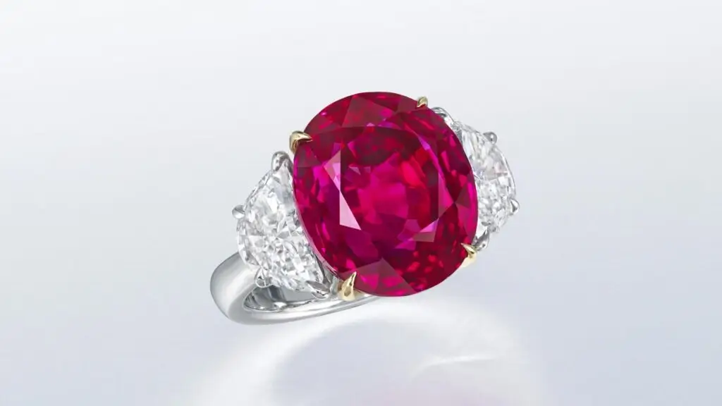 Ring featuring an oval brilliant-cut, Burmese ruby and half-moon diamond side stones at Christie's image
