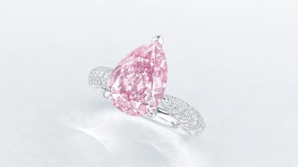 Ring featuring a pear brilliant-cut, fancy-vivid-purple-pink, internally flawless diamond center stone in a diamond-set band at Christie's image