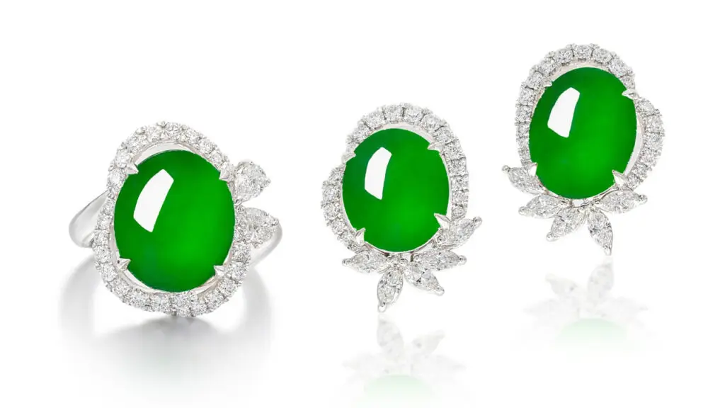 A demi-parure consisting of a ring with an oval jadeite cabochon surrounded by brilliant-cut and marquise-shaped diamonds, as well as earrings image