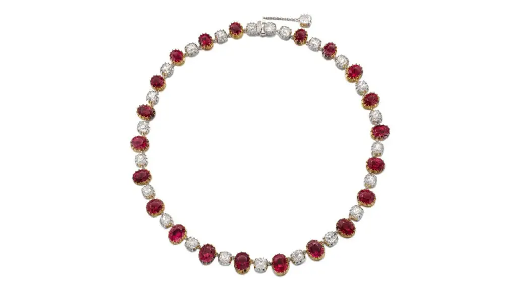 This necklace comprising 21 oval and cushion-shaped Burmese rubies with alternating old mine- and brilliant-cut diamonds at Sotheby's image