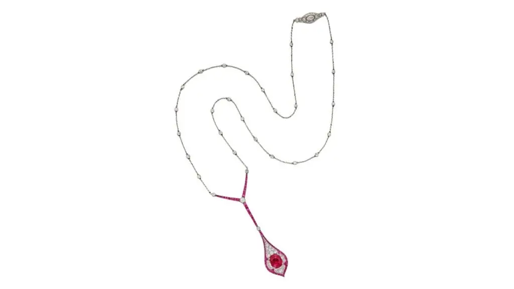 Marcus & Co. necklace featuring a Burmese ruby surrounded by old European-cut diamonds and calibré-cut rubies, suspended from a chain set with old European-cut diamonds and a diamond clasp at Sotheby's image