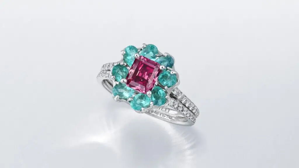 Moussaieff designed, floral ring, with fancy-purplish-red diamond with a round diamond-studded band at Christie's image