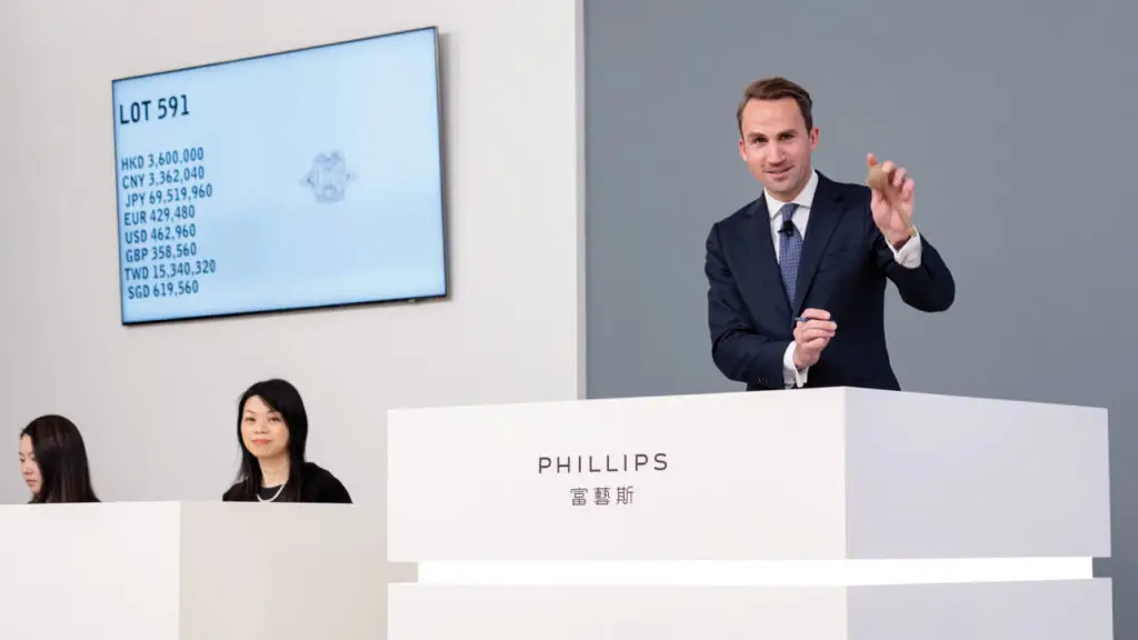 Phillips worldwide head of jewelry Benoît Repellin takes bids for a ring with a 10-carat diamond image