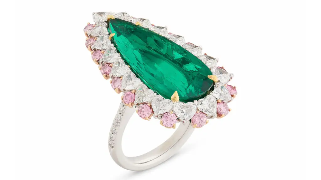 A ring with a pear-cut, 9.09-carat Colombian emerald in a surround of white heart-shaped diamonds, and round and marquise-shaped colored diamonds, with round diamonds on the band at Christie's image
