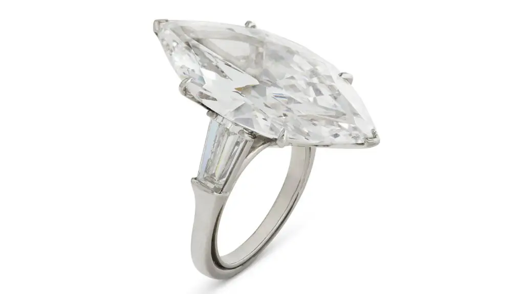 A Harry Winston ring bearing a marquise-shaped, 9.95-carat, D-color, VVS2-clarity diamond, between two trapeze-shaped diamonds at Christie's image