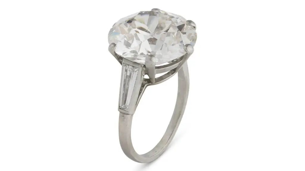 A ring centering a round, 11.51-carat, I, SI1 diamond between trapeze baguette-cut diamonds at Christie's image