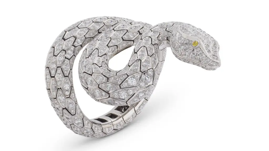 A Cartier Serpenti bracelet featuring a total of 80 carats of round diamonds, with two colored diamonds for the eyes at Christie's image