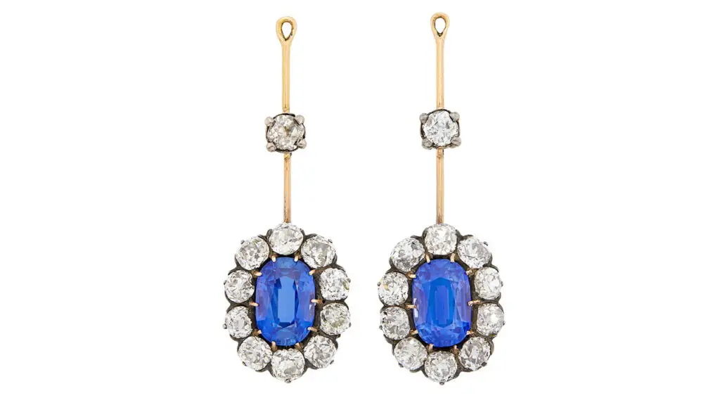 A pair of antique earrings from 1890, one sporting an oval, 4-carat Ceylon sapphire and the other an oval, 4.17- carat Kashmir sapphire, each in a surround of 10 old-mine diamonds at Doyle image